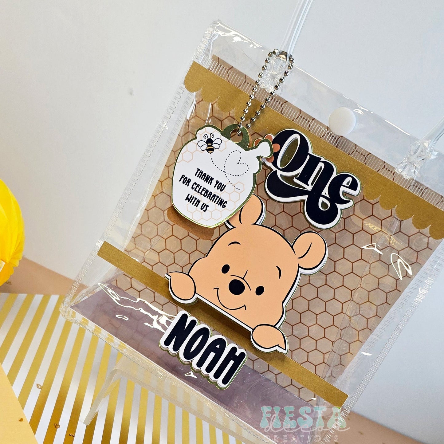 Winnie the Pooh 1st birthday clear favor bag for Noah, featuring honeycomb design & 'Thank You' tag.