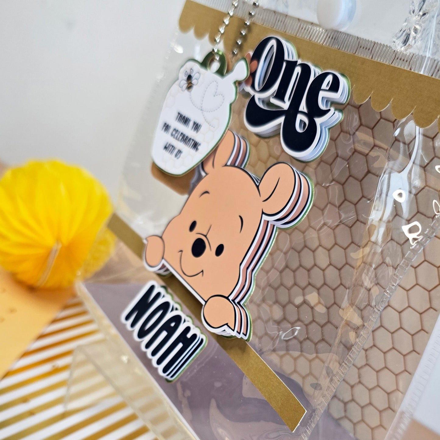 Winnie the Pooh honey-themed clear party favor pouch with Noah's name & 'One' for a 1st birthday celebration